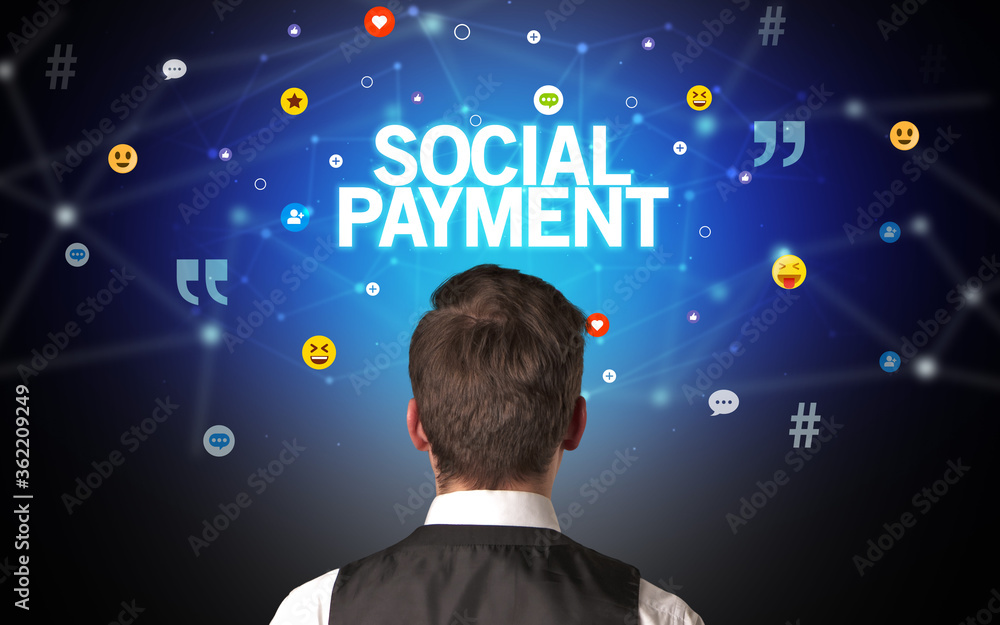 Rear view of a businessman with SOCIAL PAYMENT inscription, social networking concept Rear view of a businessman with SOCIAL PAYMENT inscription, social networking concept