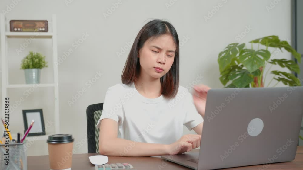 Asian business woman have a neck pain because using the laptop computer and working for a long time. This may be the cause of Office Syndrome. Asian business woman have a neck pain because using the laptop computer and working for a long time. This may be the cause of Office Syndrome.