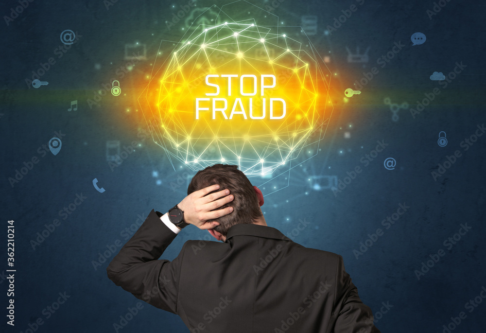 Rear view of a businessman with STOP FRAUD inscription, online security concept Rear view of a businessman with STOP FRAUD inscription, online security concept