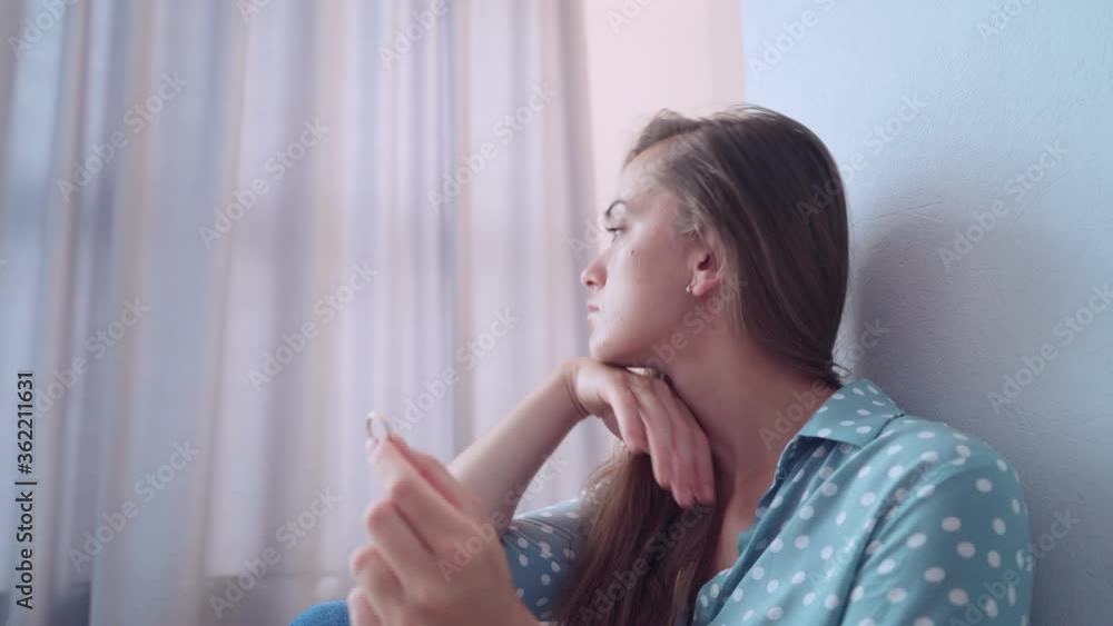 Sad lonely depressed pensive unhappy divorced woman holds marriage ring after breakup relationship and divorce Sad lonely depressed pensive unhappy divorced woman holds marriage ring after breakup relationship and divorce