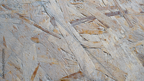 Oriented strand board (OSB) with traces of dust and plaster