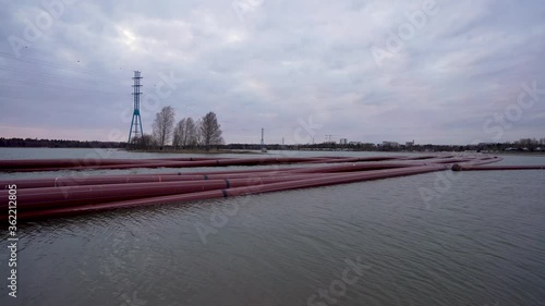 Many under water pipes waiting near Hietalahti beach for installation under water. Footage captured on cloudy evening.