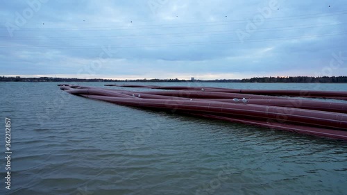 Many under water pipes waiting near Hietalahti beach for installation under water. Footage captured on cloudy evening.