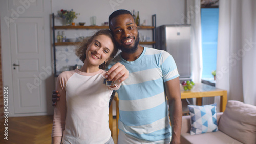 Portrait of young couple feeling happy about buying new house.