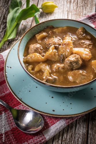 Meatballs in gravy with cast noodles.