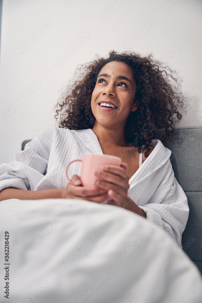 Smiling young female staring at the ceiling Smiling young female staring at the ceiling