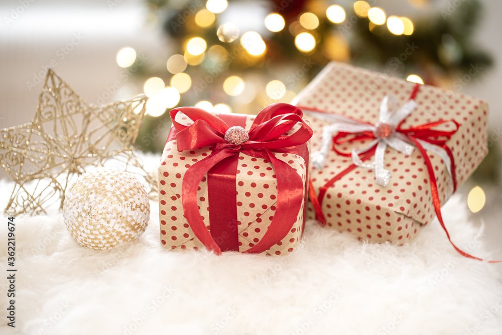 New year holiday background with a gift box in a cozy atmosphere. New year holiday background with a gift box in a cozy atmosphere.