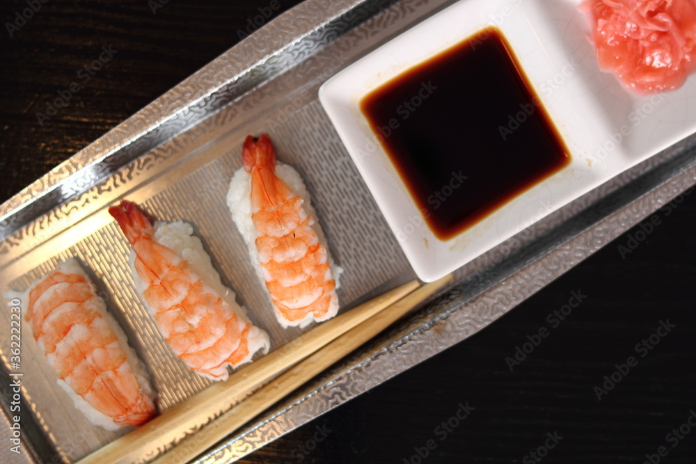 Sushi nigirizushi with soy sauce and gari on metal tray with chopsticks Sushi nigirizushi with soy sauce and gari on metal tray with chopsticks