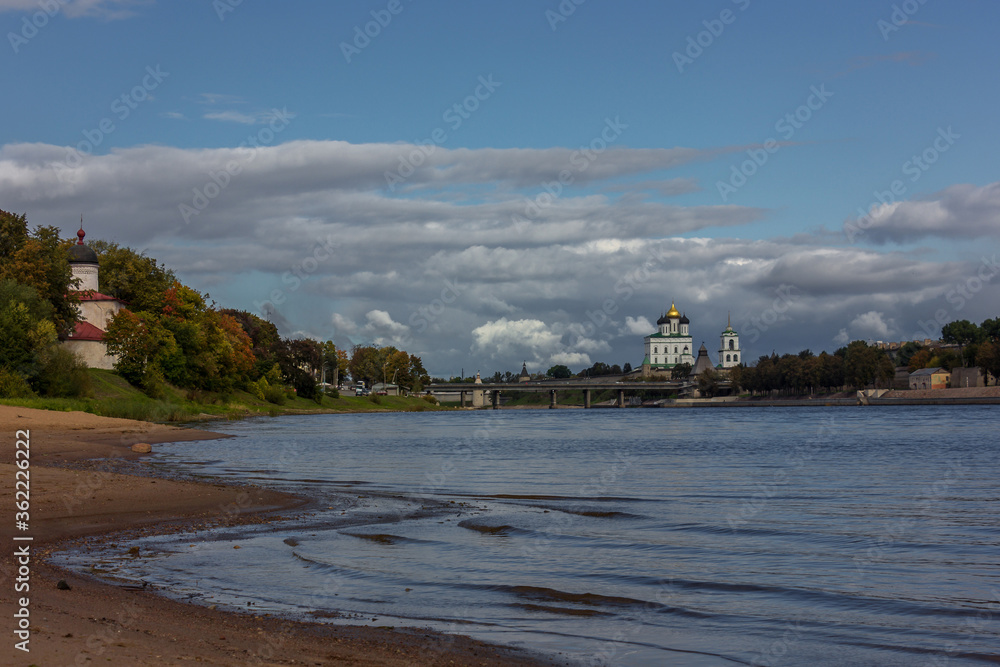 Panorama of the embankment of the river, defensive walls and towers next to the Christian Cathedral in the historical center of the old city of Pskov, Russia,