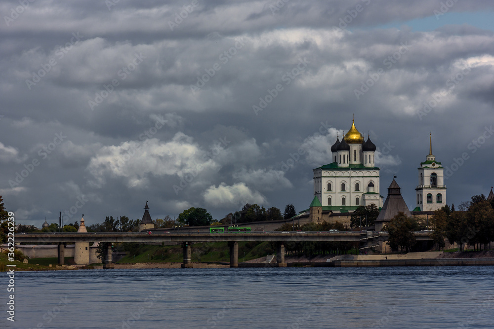 Panorama of the embankment of the river, defensive walls and towers next to the Christian Cathedral in the historical center of the old city of Pskov, Russia,