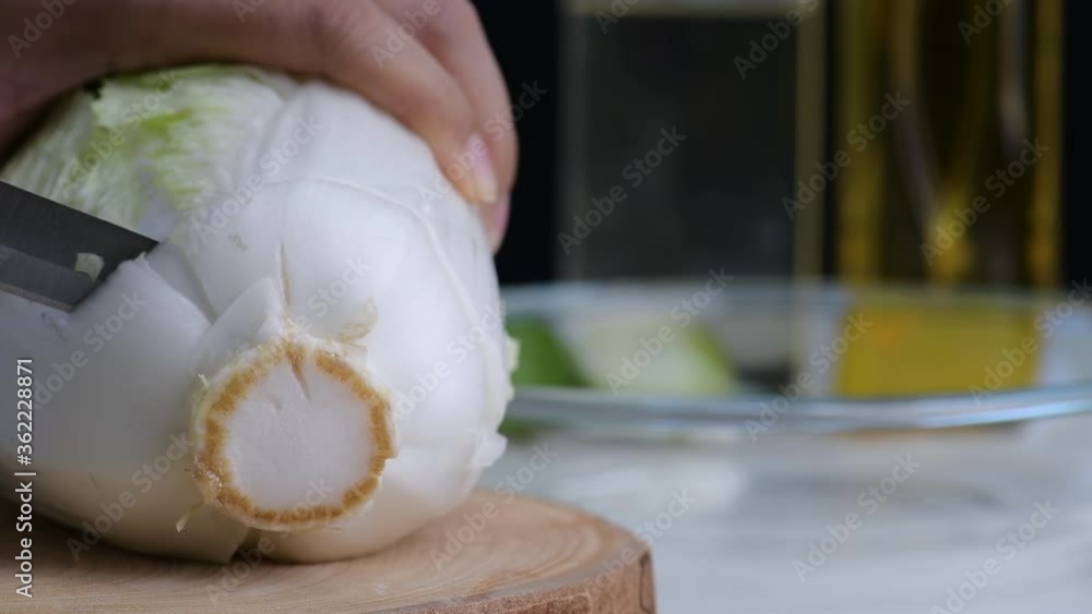 Head woman chef use knife Slice cut fresh carrot, lettuce salad on wood butcher. female hand to