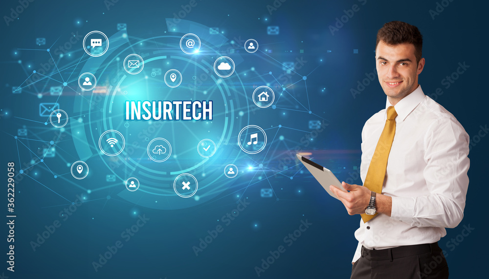 Businessman thinking in front of technology related icons and INSURTECH inscription, modern technology concept Businessman thinking in front of technology related icons and INSURTECH inscription, modern technology concept
