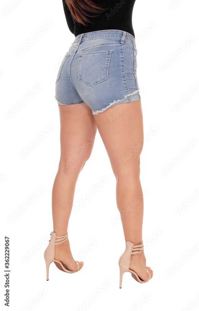 Woman standing from back in jeans shorts