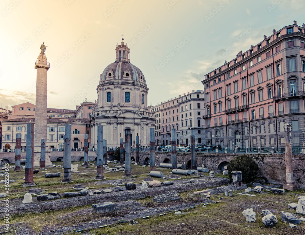Obraz premium golden hour in Caesar's and Trajan's forum ruins with St.Mary church domes on the babckground, Rome Italy