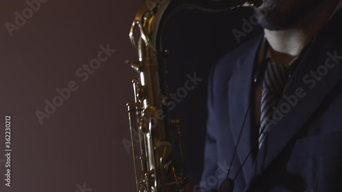 Caucasian saxophone player in a club. Jazz and blues concept