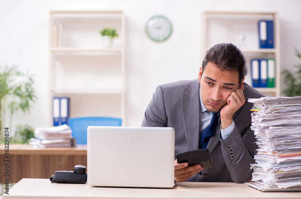 Young male businessman unhappy with excessive work Young male businessman unhappy with excessive work