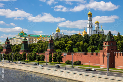 Panoramic view of the historical center of Moscow Russia with the red brick Kremlin wall and the assumption Cathedral with Golden domes against a bright blue sky and space for copying