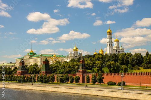Panoramic view of the historical center of Moscow Russia with the red brick Kremlin wall and the assumption Cathedral with Golden domes against a bright blue sky and space for copying