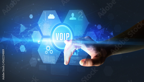 Hand touching VOIP inscription, new technology concept