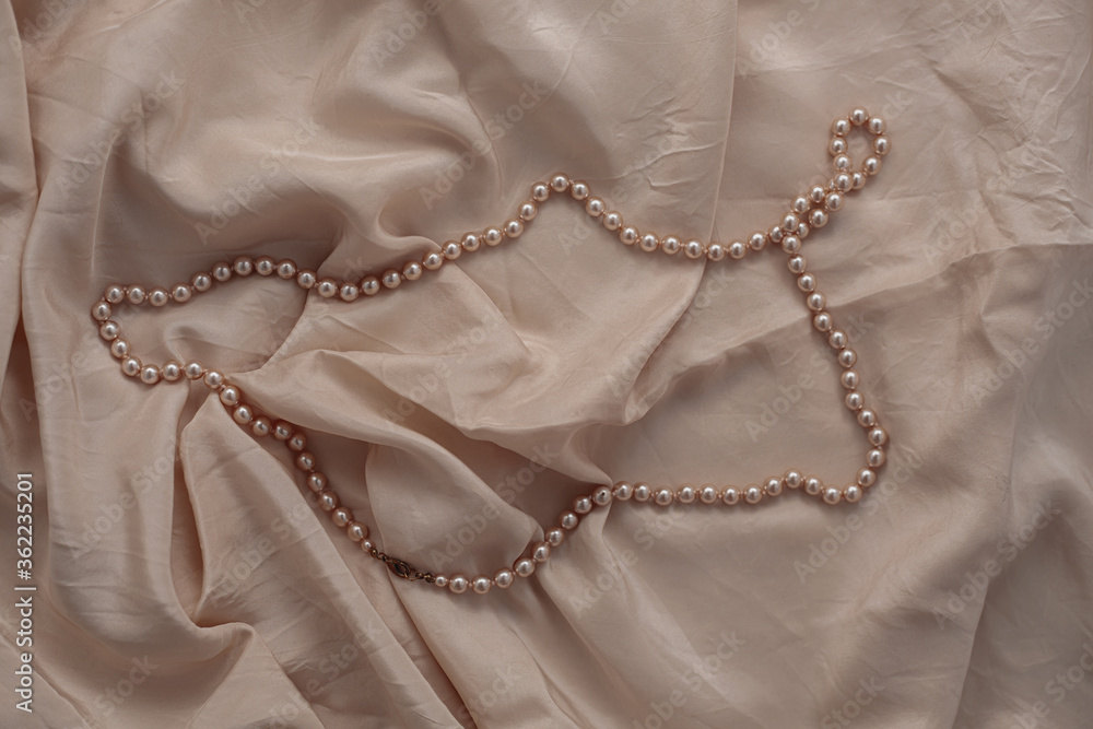 Pearl necklace on beige fabric. Pearl necklace on beige fabric.