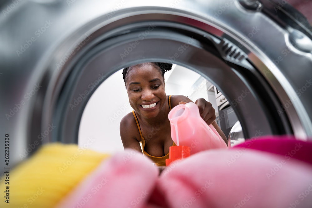 Woman Using Washing Machine Filling Soap Woman Using Washing Machine Filling Soap