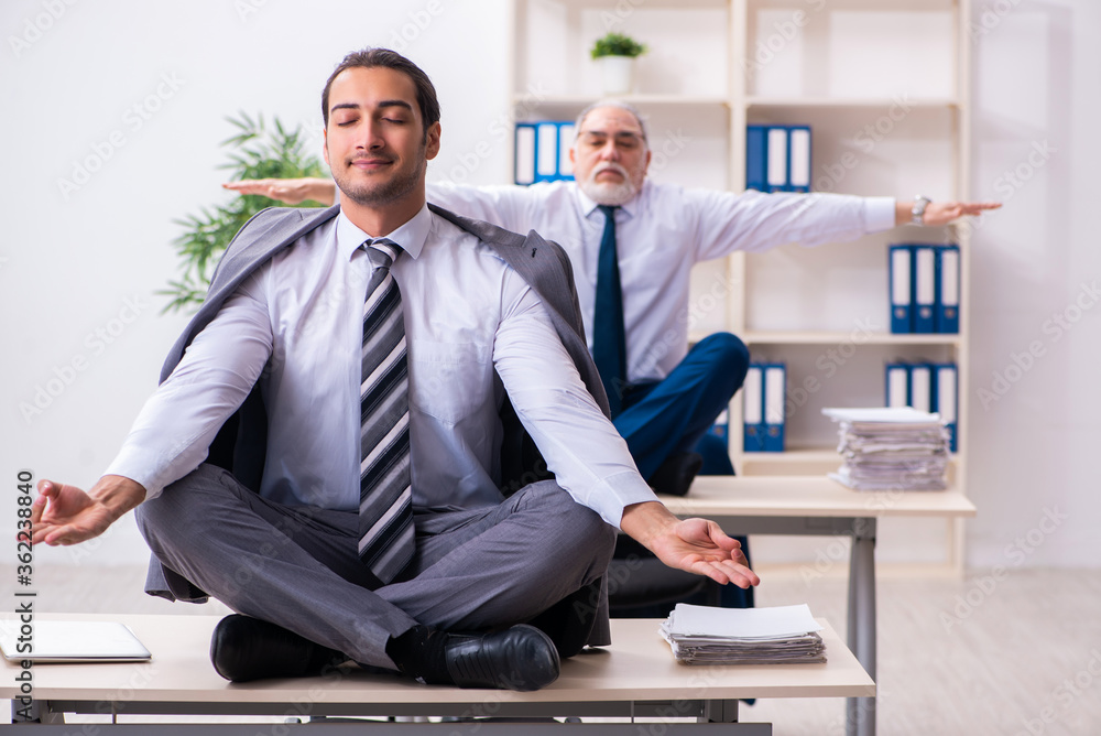 Fototapeta premium Two male employees working in the office