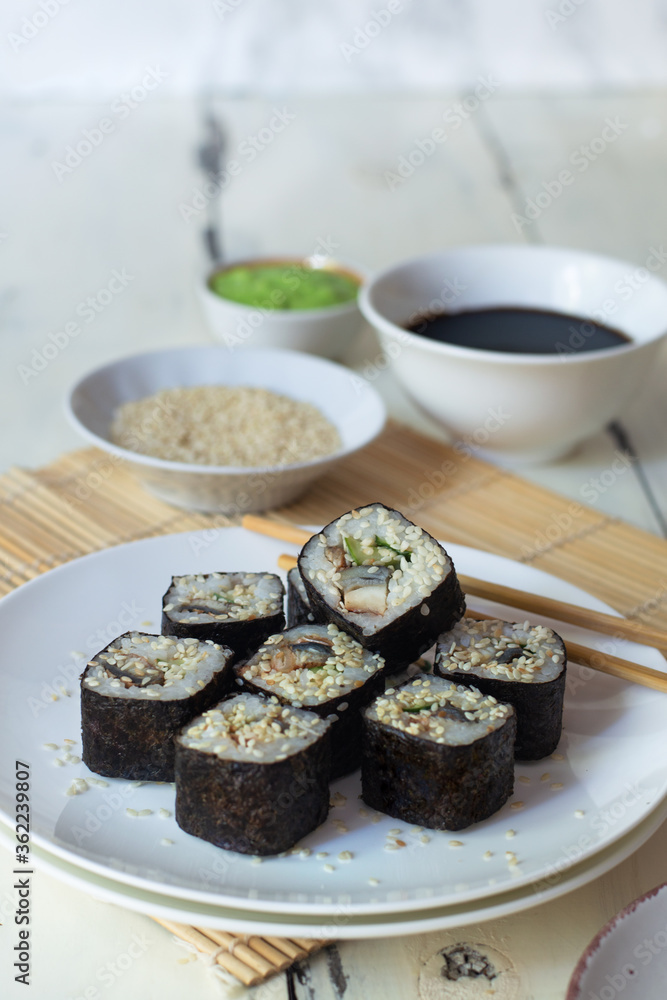 Sushi rolls with eel, sesame, cucumber and wasabi Sushi rolls with eel, sesame, cucumber and wasabi