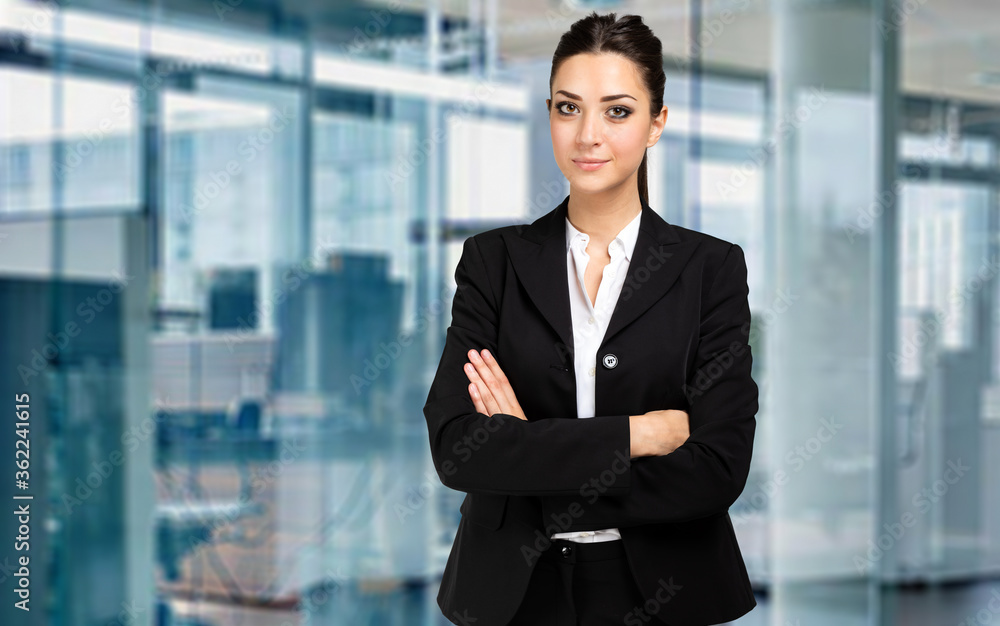 Smiling businesswoman portrait in a modern office Smiling businesswoman portrait in a modern office