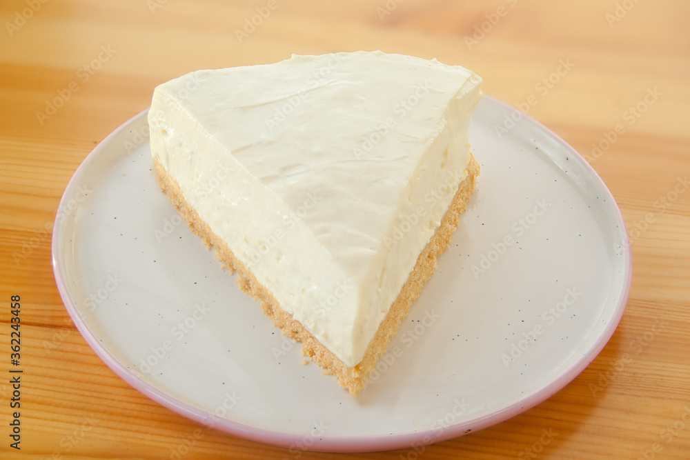 classic cheesecake on white plate on wooden table classic cheesecake on white plate on wooden table