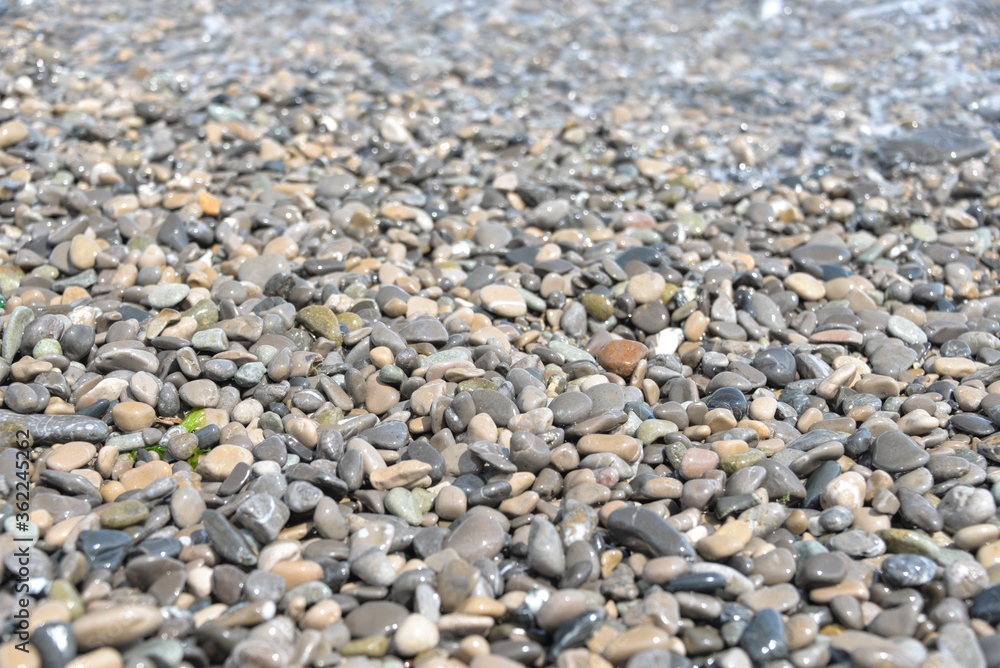 average waves on the sea reach the shore with foam and crash on the rocks with a noise average waves on the sea reach the shore with foam and crash on the rocks with a noise
