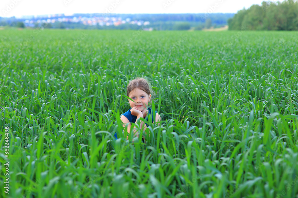 Beautiful little girl runs in the summer field Beautiful little girl runs in the summer field