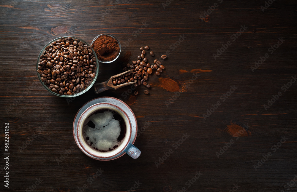Vintage coffee background with space for text. Still life with cups of coffee, coffee beans and ground powder on wood table background. Flat lay.