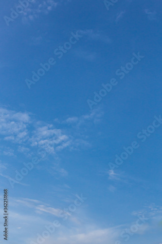 The sky on a sunny day with clouds floating in a lump for a clear feeling. Use as a vertical background that feels clear and relaxed. 