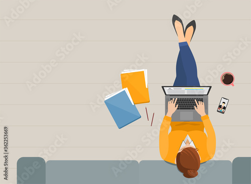 Woman working in the living room with laptop at home top view