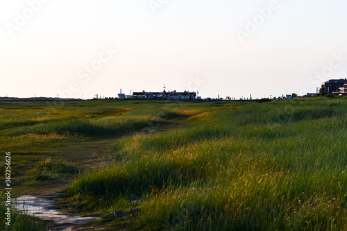 Hiking through the dune landscape in St. Peter Ording with the setting sun