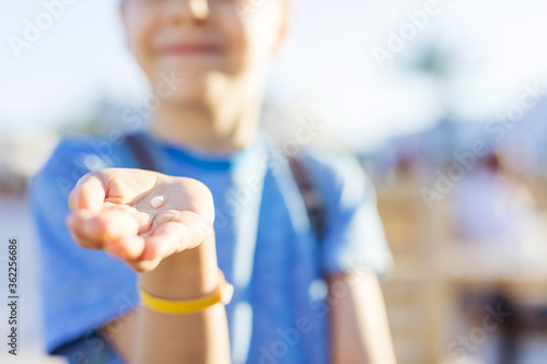 Young boy showing a tooth he has just lost