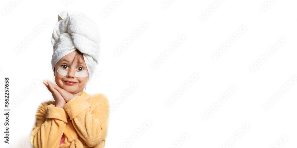 Cute girl in a yellow bathrobe with eye patches Cute girl in a yellow bathrobe with eye patches