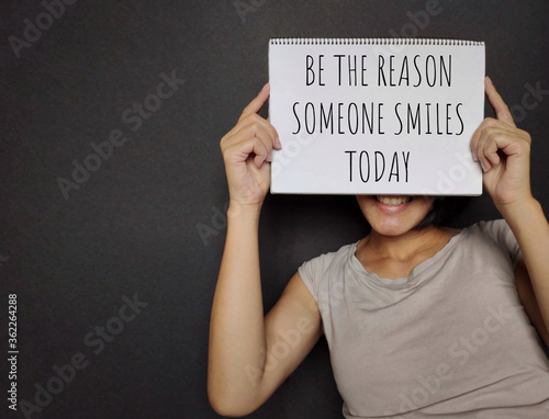 BE THE REASON SOMEONE SMILES TODAY text written on paper. Stock photo.
