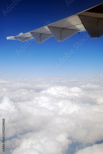 View of the wing of the airplane over the clouds in Romania.