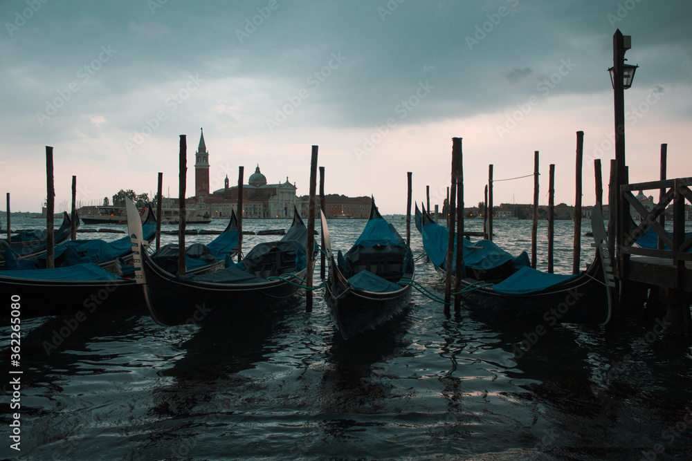 Gondolas parked on a pier in Venice Italy