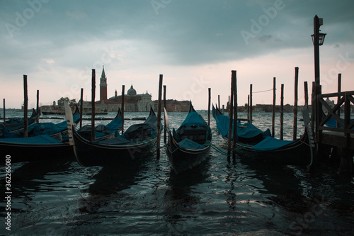 Gondolas parked on a pier in Venice Italy © Alex Wolf 