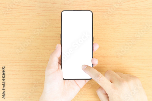 top view of hand holding white screen smartphone on hand