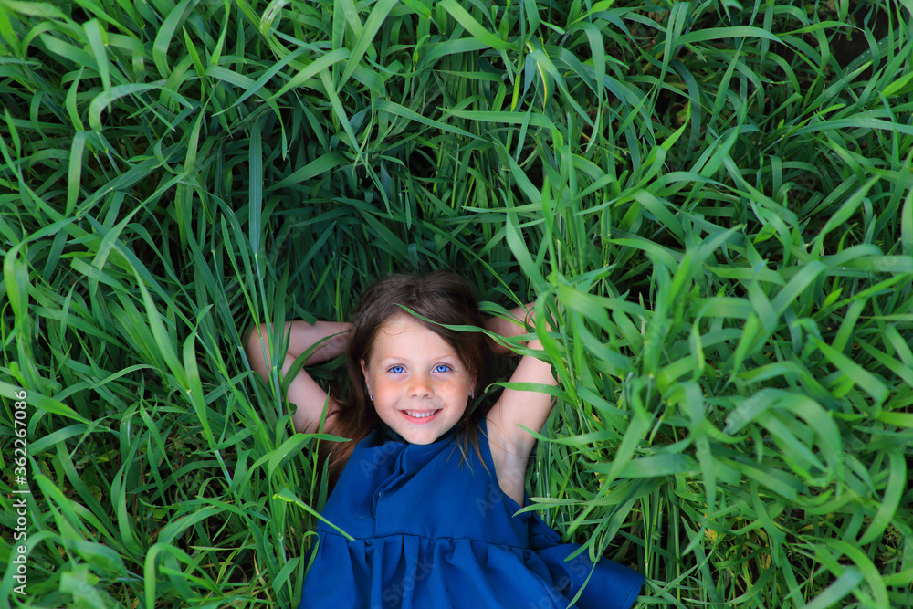 Beautiful little girl runs in the summer field Beautiful little girl runs in the summer field