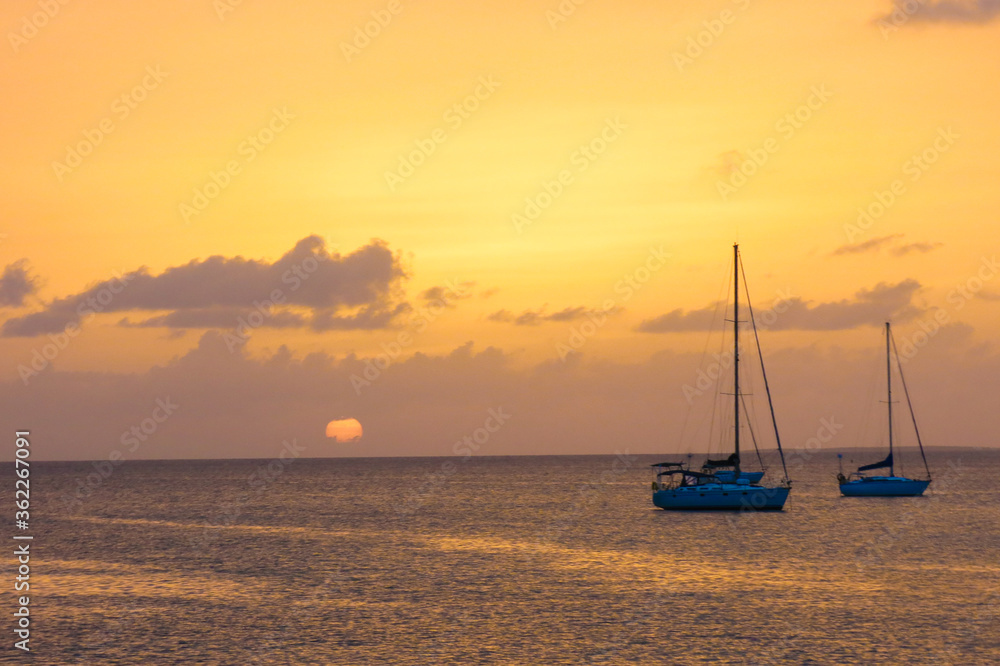 Sunset behind sailboats in the Caribbean