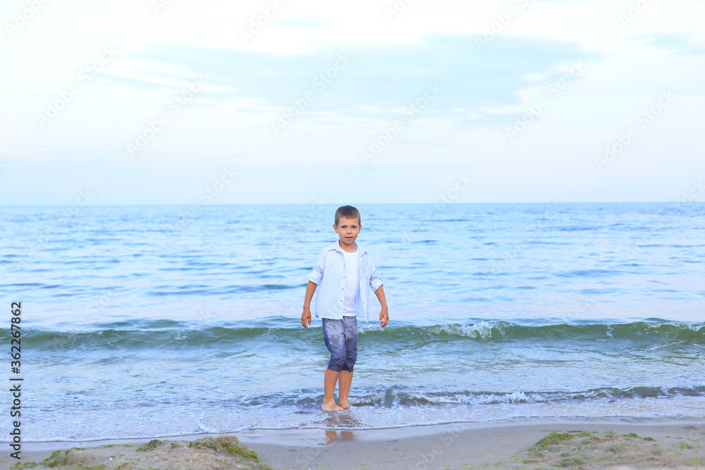 A boy runs on the water near the sea