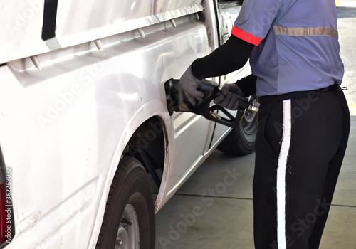 close up hand of Fueling staff Close up pumping gasoline fuel in car at gas station
