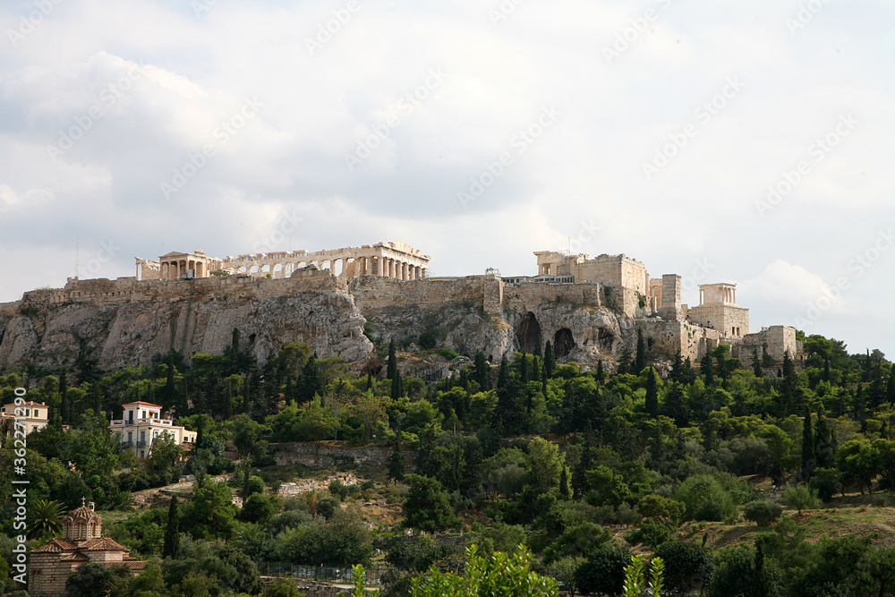 View of Acropolis in Athens Greece with stormy sky and plants in foreground