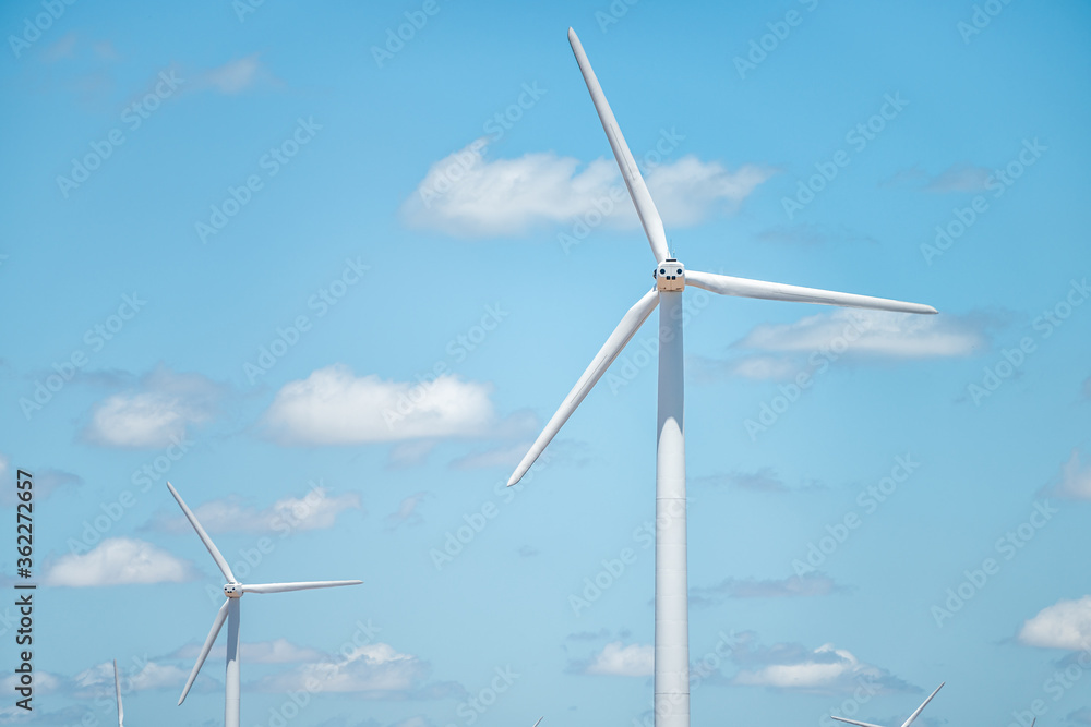 Wind turbine farm mill closeup near Snyder Roscoe and Sweetwater Texas in USA isolated against sky Wind turbine farm mill closeup near Snyder Roscoe and Sweetwater Texas in USA isolated against sky