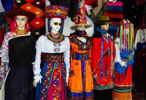 Mannequins dressed in national costumes of Ecuador and Peru on the display in dress shop for selling.