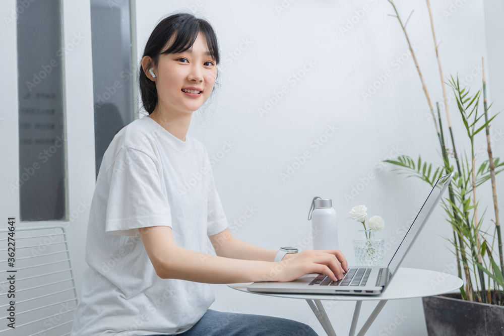 In the study, a pure girl is using a computer